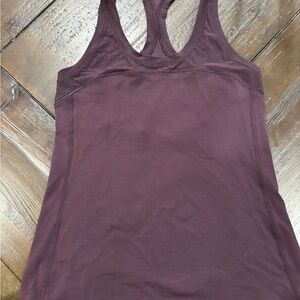 Lulu lemon eggplant colored muscle  Tank Top. This is cut longer then new tanks